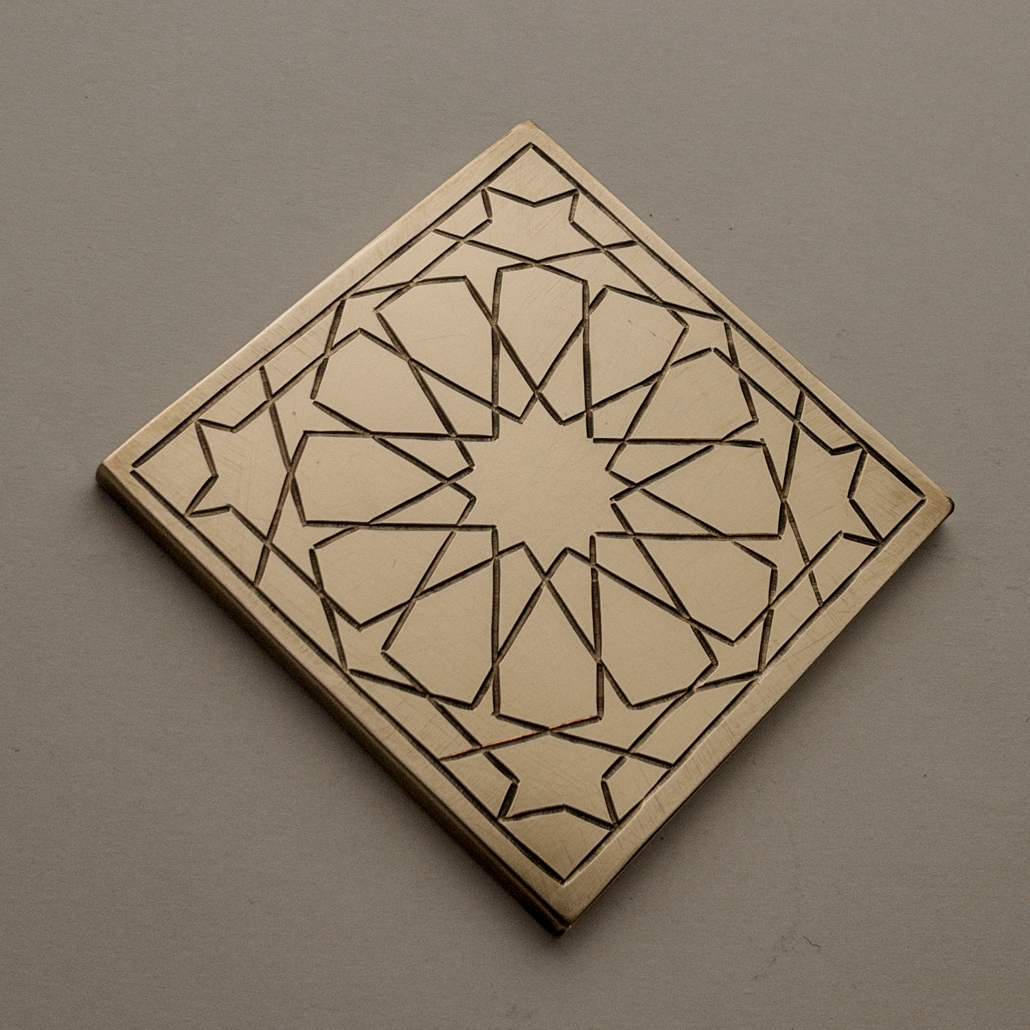 HAND-ENGRAVED BRASS COASTER