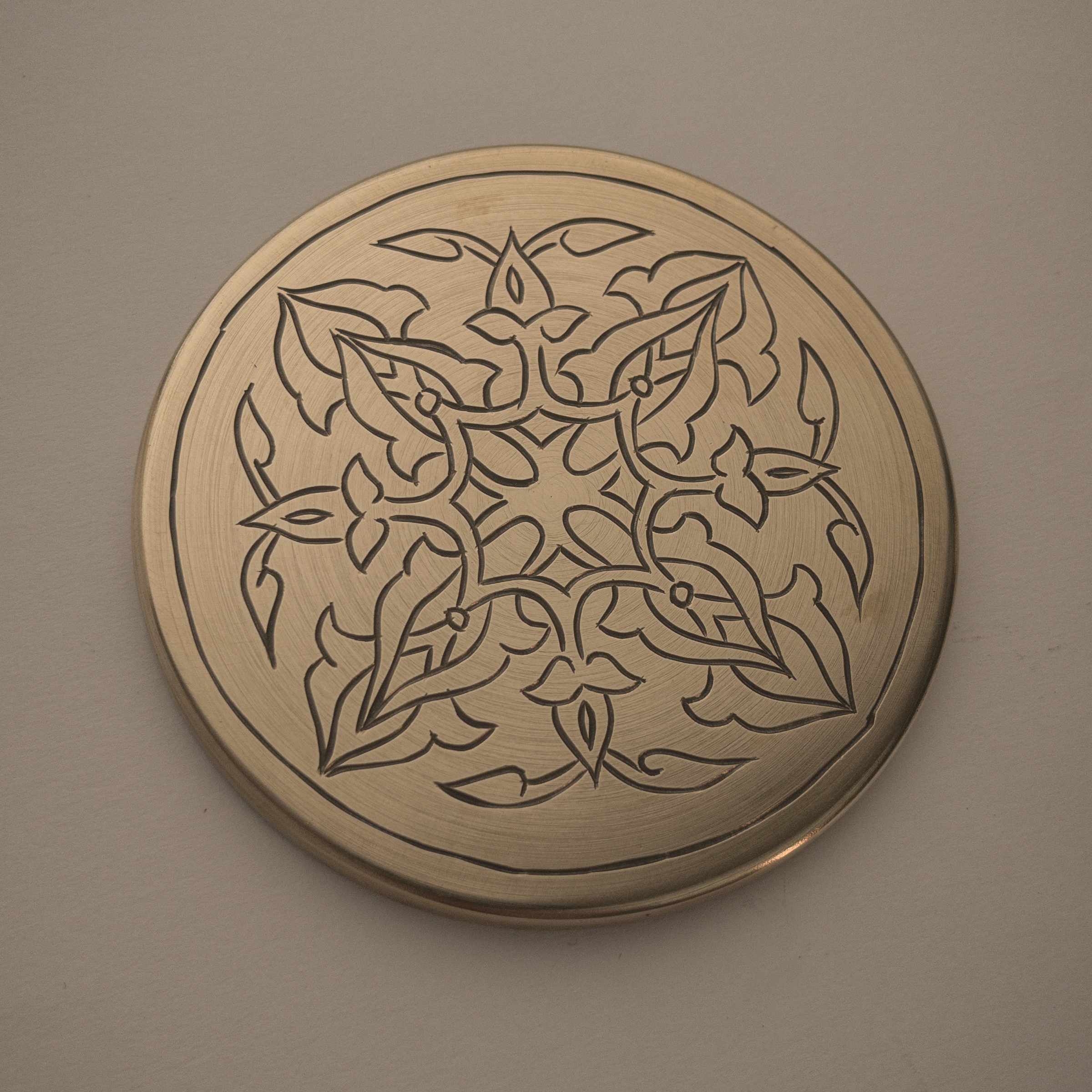 HAND-ENGRAVED BRASS COASTER
